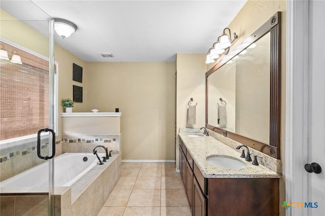 4 Longview Dr, Victoria, TX 77904 - full bathroom with a garden tub, double vanity, tiled shower, tile patterned floors, and baseboards