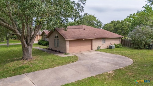 4 Longview Dr, Victoria, TX 77904 - view of side of home featuring central AC, driveway, brick siding, an attached garage, and roof with shingles
