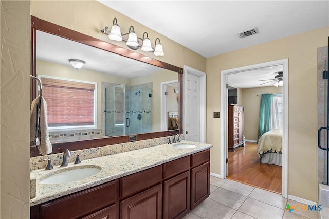 4 Longview Dr, Victoria, TX 77904 - ensuite bathroom featuring tile patterned floors, a stall shower, double vanity, and baseboards