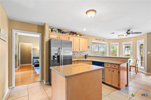 4 Longview Dr, Victoria, TX 77904 - kitchen featuring appliances with stainless steel finishes, a sink, a peninsula, a center island, and light tile patterned flooring