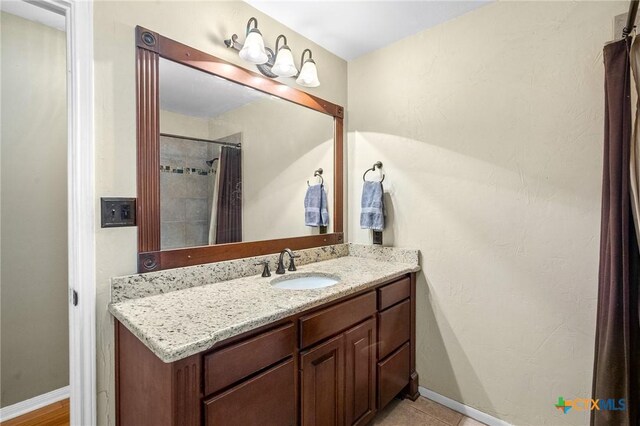 4 Longview Dr, Victoria, TX 77904 - full bathroom with vanity, baseboards, and a shower with curtain