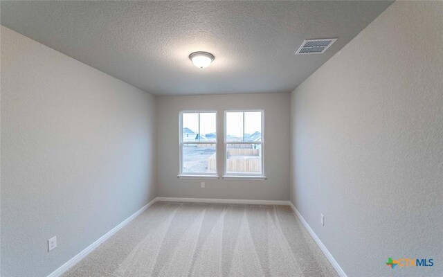308 Angus Dr, Seguin, TX 78155 - spare room featuring a textured wall, visible vents, baseboards, and light carpet