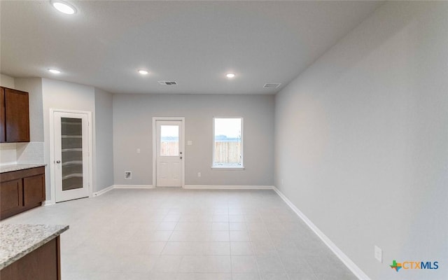 308 Angus Dr, Seguin, TX 78155 - unfurnished living room with recessed lighting, visible vents, baseboards, and light tile patterned floors
