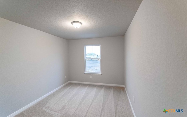 308 Angus Dr, Seguin, TX 78155 - unfurnished room with baseboards, a textured ceiling, and light colored carpet
