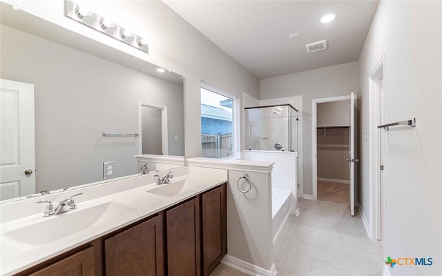 308 Angus Dr, Seguin, TX 78155 - bathroom with tile patterned flooring, a sink, visible vents, and a stall shower