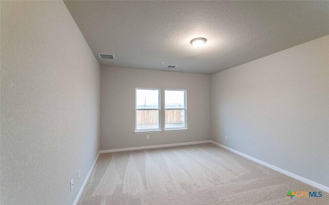 308 Angus Dr, Seguin, TX 78155 - carpeted empty room featuring baseboards, a textured ceiling, and visible vents