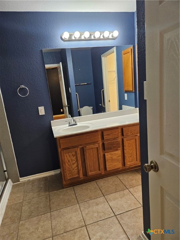 bathroom with tile patterned floors and vanity