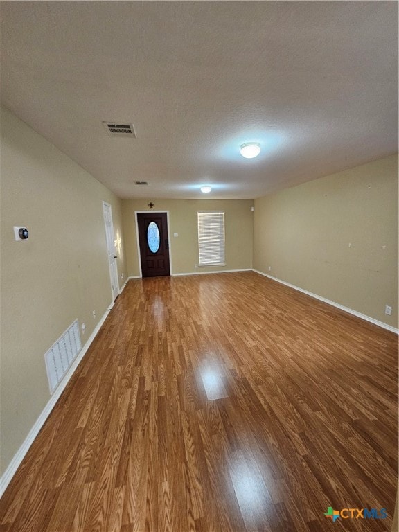 interior space featuring hardwood / wood-style floors and a textured ceiling