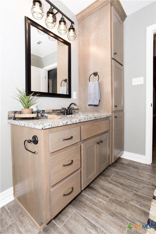 bathroom featuring vanity and hardwood / wood-style flooring