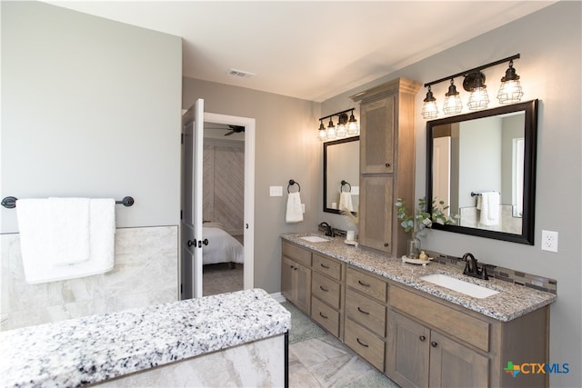 bathroom featuring vanity and ceiling fan