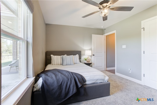 bedroom with access to exterior, carpet floors, and ceiling fan