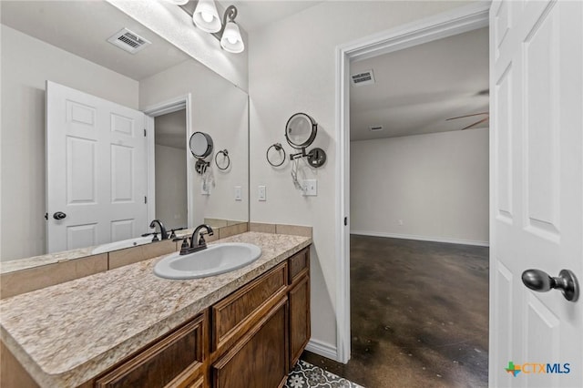 bathroom featuring ceiling fan, vanity, and concrete flooring