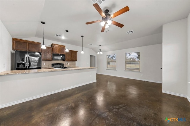 kitchen with lofted ceiling, black appliances, decorative backsplash, hanging light fixtures, and light stone countertops