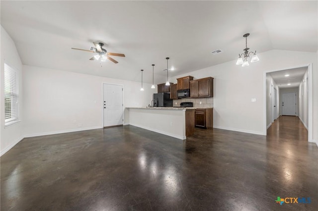 interior space with ceiling fan with notable chandelier, black appliances, lofted ceiling, tasteful backsplash, and hanging light fixtures