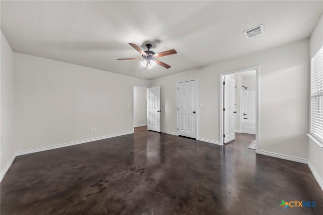 unfurnished bedroom featuring ceiling fan and ensuite bath