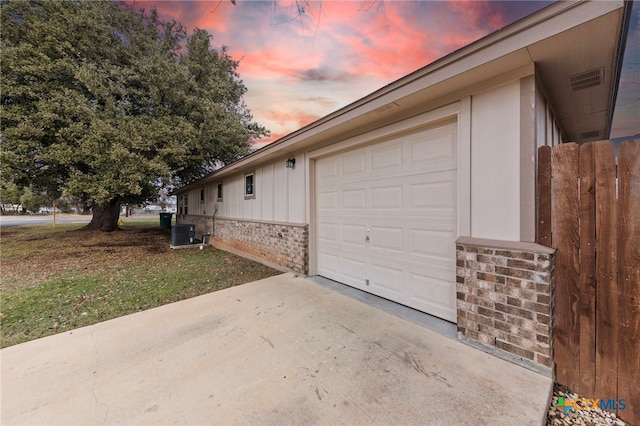 exterior space featuring central AC unit and a garage