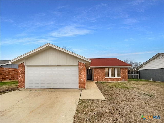 ranch-style house featuring driveway, a garage, and brick siding