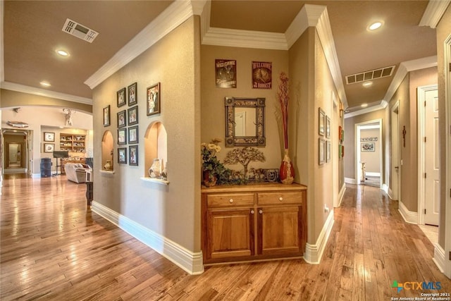547 Powder Rdg, Luling, TX 78648 - hallway with crown molding, light wood-style floors, recessed lighting, and arched walkways