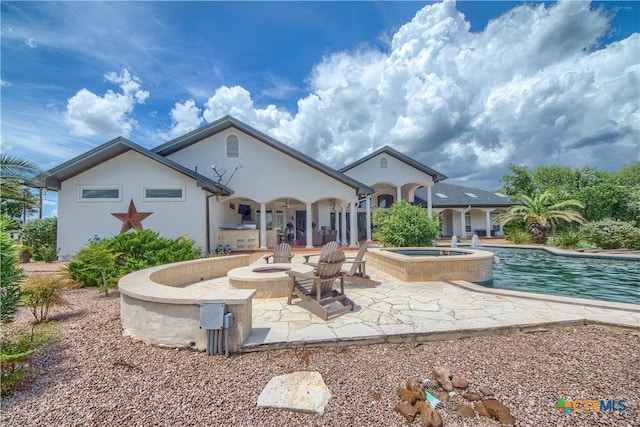 547 Powder Rdg, Luling, TX 78648 - back of house with a patio, a pool with connected hot tub, and stucco siding