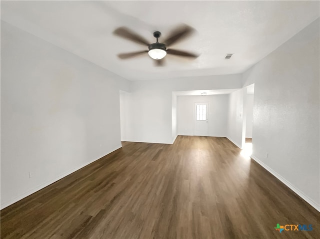 unfurnished room with dark wood-type flooring and ceiling fan