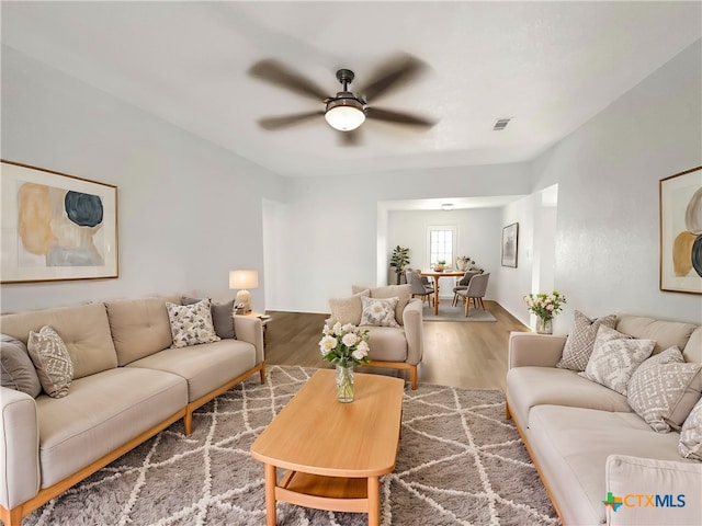 living room featuring hardwood / wood-style flooring and ceiling fan