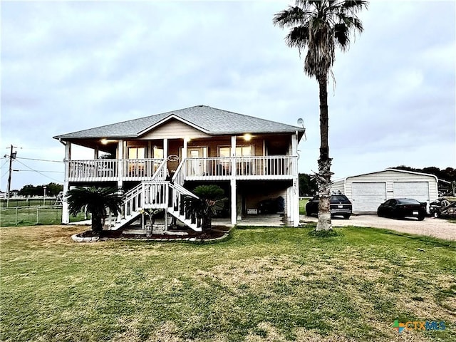 view of front of home featuring a front yard, a porch, and a garage