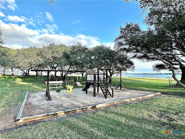 surrounding community with a playground, a yard, and a water view