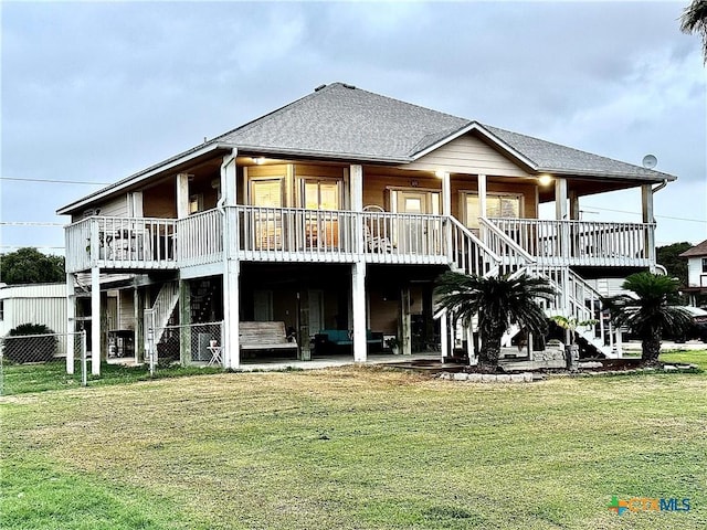 rear view of property featuring a lawn