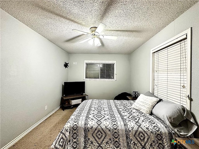 bedroom with carpet flooring, a textured ceiling, and ceiling fan