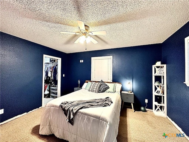 bedroom with carpet, a textured ceiling, a closet, and ceiling fan