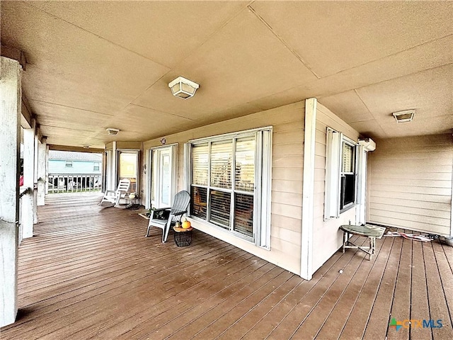 wooden terrace featuring covered porch