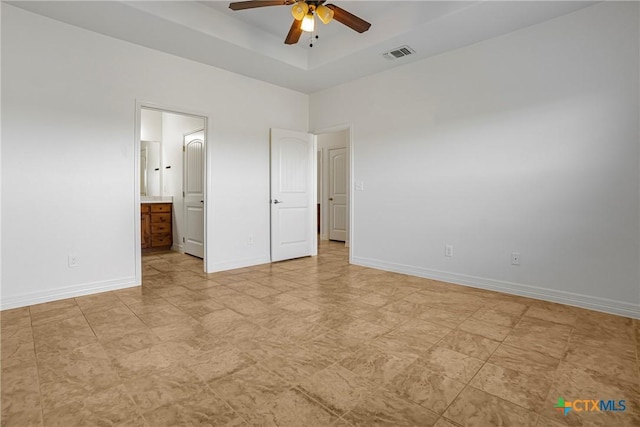 1121 Swanflower Ln, Temple, TX 76502 - unfurnished bedroom featuring ensuite bathroom, ceiling fan, a tray ceiling, baseboards, and visible vents