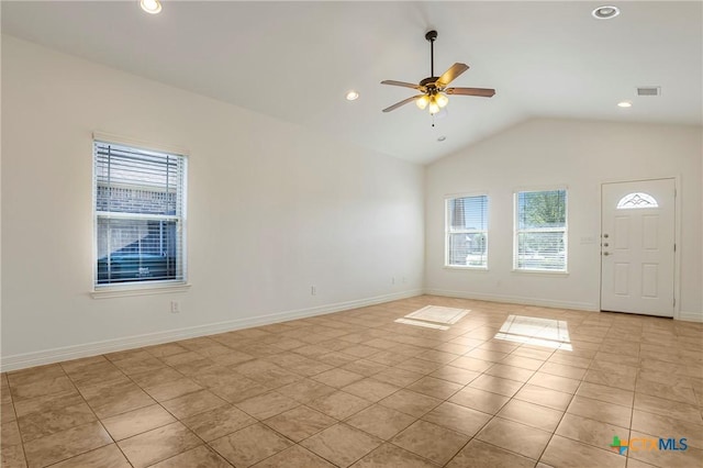 1121 Swanflower Ln, Temple, TX 76502 - empty room with light tile patterned floors, vaulted ceiling, a wealth of natural light, and ceiling fan