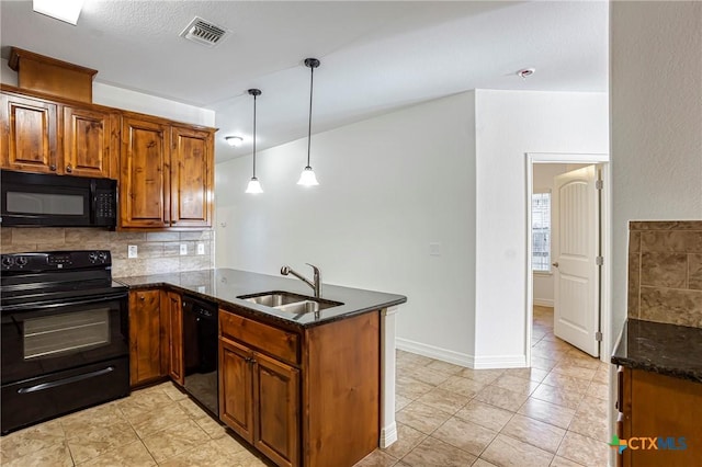 1121 Swanflower Ln, Temple, TX 76502 - kitchen with a peninsula, a sink, dark stone counters, visible vents, and black appliances