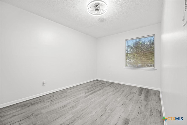 1206 Amthor Ave, Copperas Cove, TX 76522 - unfurnished room with a textured ceiling, wood finished floors, and baseboards