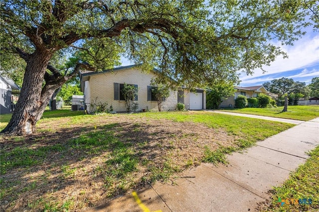 1206 Amthor Ave, Copperas Cove, TX 76522 - view of front of house with a garage, brick siding, concrete driveway, and a front lawn