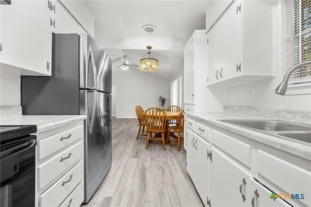 1206 Amthor Ave, Copperas Cove, TX 76522 - kitchen with a sink, healthy amount of natural light, freestanding refrigerator, range, and vaulted ceiling