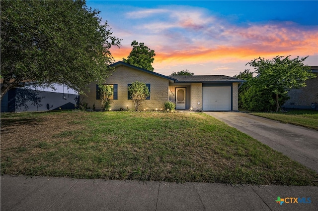 1206 Amthor Ave, Copperas Cove, TX 76522 - view of front of property featuring an attached garage, concrete driveway, brick siding, and a yard