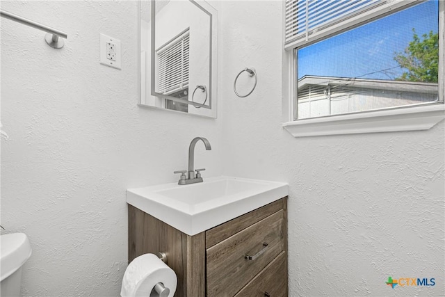 1206 Amthor Ave, Copperas Cove, TX 76522 - half bathroom featuring toilet, a textured wall, and vanity