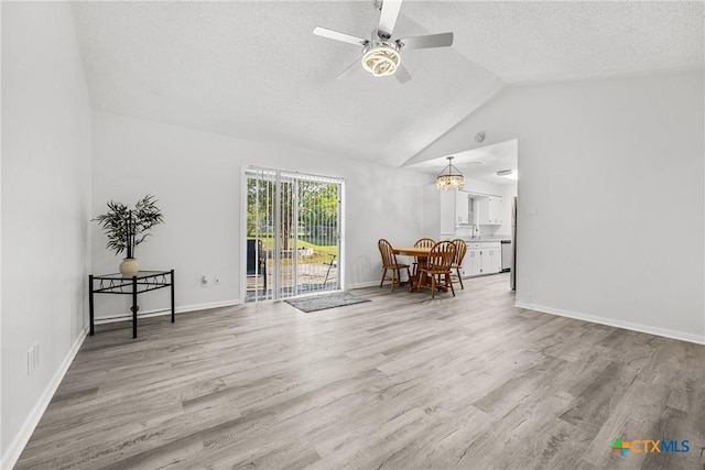 1206 Amthor Ave, Copperas Cove, TX 76522 - living room featuring a textured ceiling, ceiling fan, wood finished floors, baseboards, and high vaulted ceiling
