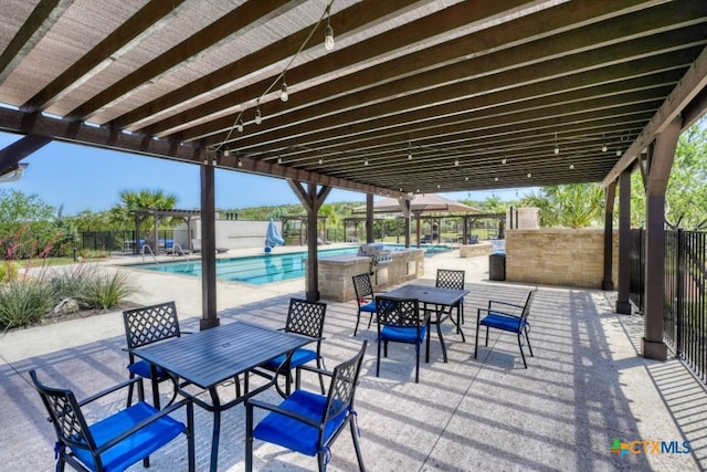 119 Rivalto Dr, Horseshoe Bay, TX 78657 - view of patio / terrace with outdoor dining area, a community pool, and a pergola
