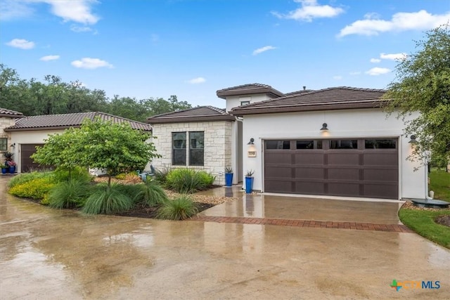 119 Rivalto Dr, Horseshoe Bay, TX 78657 - view of front of home featuring a garage, driveway, stucco siding, stone siding, and a tile roof