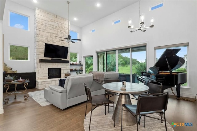 119 Rivalto Dr, Horseshoe Bay, TX 78657 - living room featuring a towering ceiling, healthy amount of natural light, wood finished floors, a ceiling fan, and recessed lighting