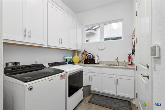 119 Rivalto Dr, Horseshoe Bay, TX 78657 - laundry room with washing machine and clothes dryer, cabinet space, and light tile patterned floors