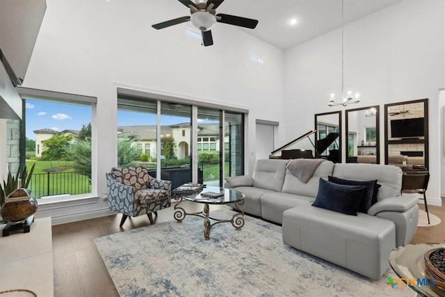 119 Rivalto Dr, Horseshoe Bay, TX 78657 - living area featuring wood finished floors, a high ceiling, a chandelier, and a ceiling fan
