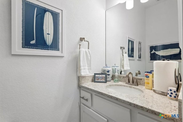 119 Rivalto Dr, Horseshoe Bay, TX 78657 - bathroom with vanity and a textured wall
