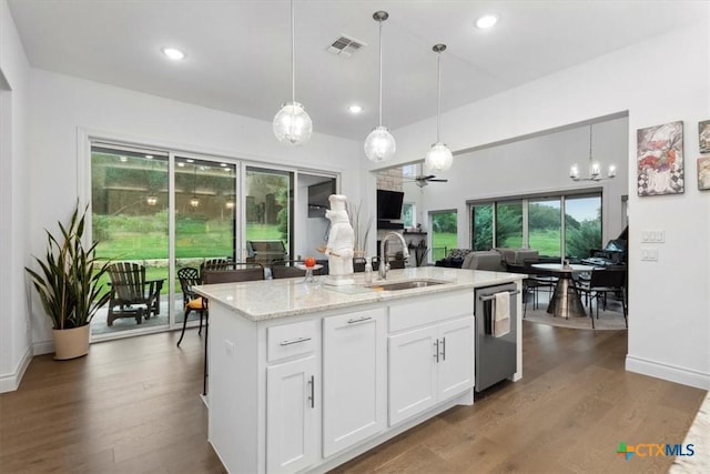 119 Rivalto Dr, Horseshoe Bay, TX 78657 - kitchen featuring stainless steel dishwasher, a sink, healthy amount of natural light, light stone countertops, and recessed lighting