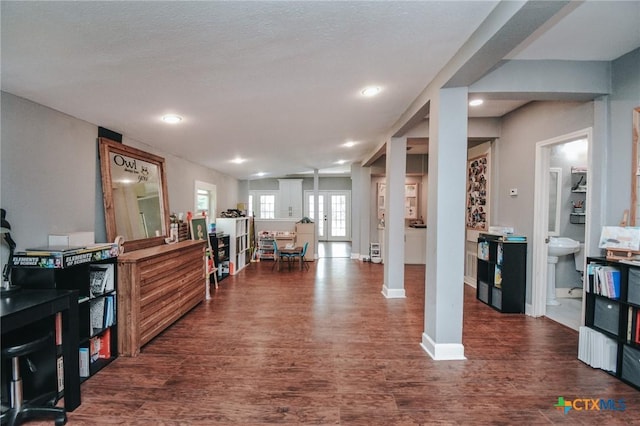 living room featuring recessed lighting, baseboards, french doors, and dark wood-type flooring