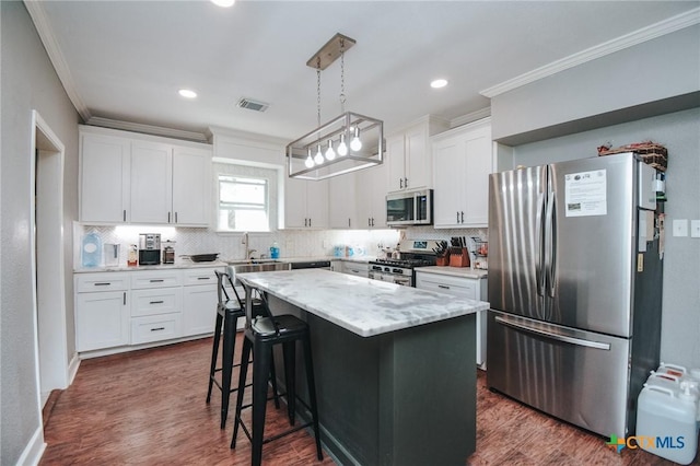 kitchen featuring crown molding, appliances with stainless steel finishes, tasteful backsplash, and visible vents