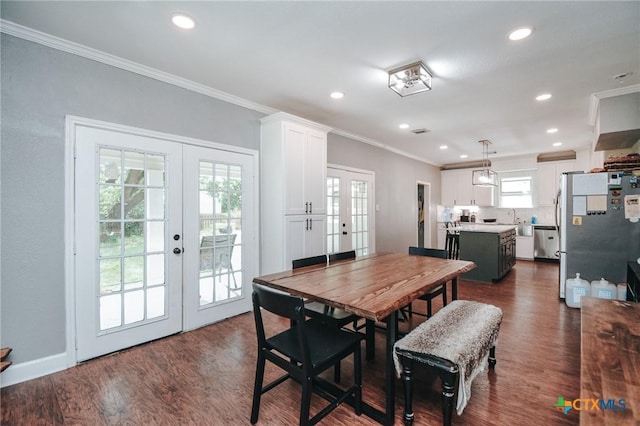 dining area featuring crown molding, dark wood-style floors, and french doors